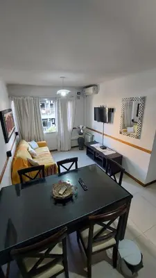 a living room with a table and a bed at Departamento Céntrico Miralejos 2 in Villa Carlos Paz