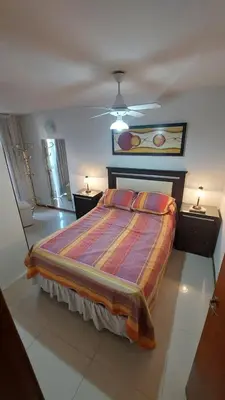 a bedroom with a bed and a ceiling fan at Departamento Céntrico Miralejos 2 in Villa Carlos Paz