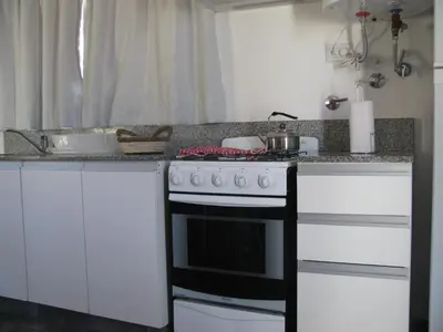 a kitchen with a stove and a counter top at Balcones de Los Chorrillos in Estancia Vieja