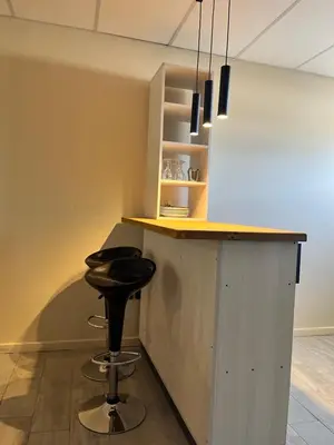 a kitchen with a counter with a stool at a bar at Único y hermoso in Cordoba