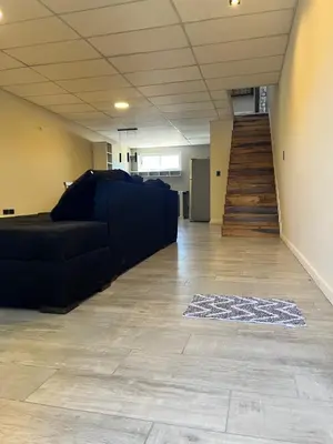 an empty room with a couch and a staircase at Único y hermoso in Cordoba