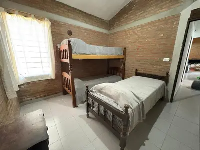 a bedroom with two bunk beds and a window at CASA EL GRINGO ubicada en Villa Parque Siquiman con vista al río tres habitaciones y capacidad para ocho personas in Villa Parque Siquiman