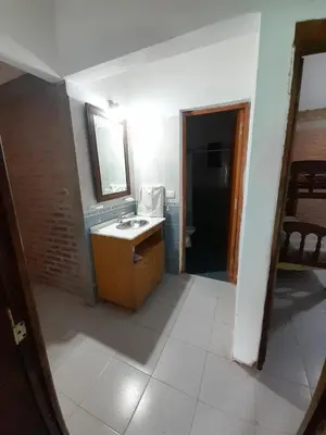 a bathroom with a sink and a mirror at CASA EL GRINGO ubicada en Villa Parque Siquiman con vista al río tres habitaciones y capacidad para ocho personas in Villa Parque Siquiman