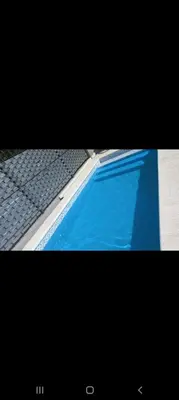 a close up of a blue swimming pool at La casita in Villa Carlos Paz