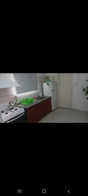 a kitchen with a stove and a white refrigerator at La casita in Villa Carlos Paz