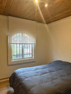 a bedroom with a bed and a window at Casa La Tranquilidad in La Porteña