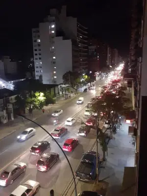 a busy city street filled with cars at night at Cordoba temporario in Cordoba