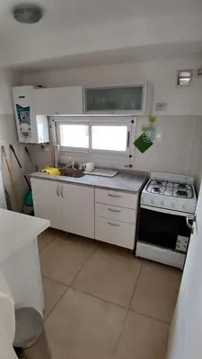 a small kitchen with a stove and a sink at Cordoba temporario in Cordoba
