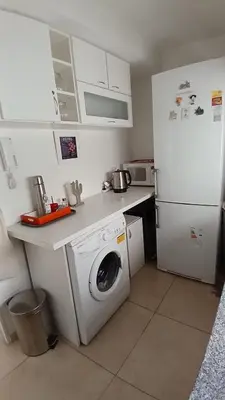 a kitchen with a washing machine and a refrigerator at Cordoba temporario in Cordoba