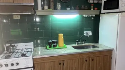 a kitchen with a sink and a stove at Departamento en calle Ayacucho in Cordoba