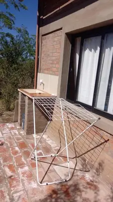 a metal object sitting on top of a patio at Cabaña Zara in Villa Yacanto