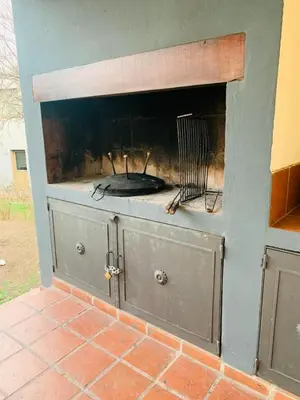 a fire place in a brick wall with a fireplace at La Estanzuela FM in La Calera