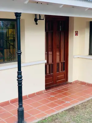 a front door of a house with a brick floor at La Estanzuela FM in La Calera