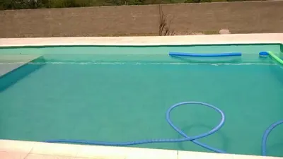 a swimming pool with a hose in the water at Casa Tanti in Tanti