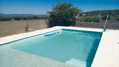 a swimming pool on the side of a house at Casa Tanti in Tanti