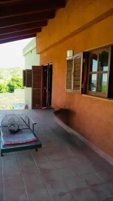 a building with a dog laying on a bed on a patio at Casa Tanti in Tanti