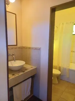 a bathroom with a sink and a toilet at Cabañas El Paso in Villa del Dique