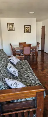 a bedroom with two beds and a table and chairs at Dpto temporario Cba in Cordoba