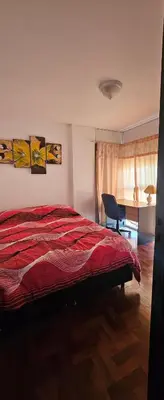a bedroom with a bed and a desk and a chair at Dpto temporario Cba in Cordoba