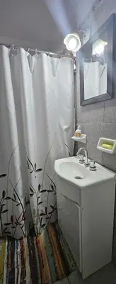 a bathroom with a sink and a shower curtain at Dpto temporario Cba in Cordoba