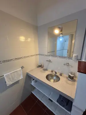 a bathroom with a sink and a mirror at Casa con vista y acceso al río in Villa Icho Cruz