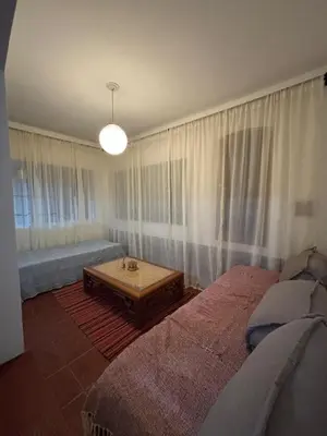 a living room with a bed and a coffee table at Casa con vista y acceso al río in Villa Icho Cruz