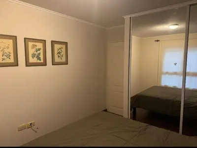 a bedroom with a mirror and a bed in it at Departamento un dormitorio Frente al Pocito in Cordoba