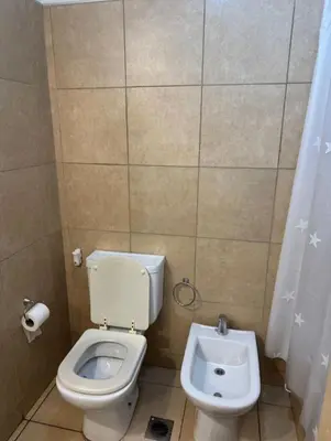 a bathroom with a toilet and a bidet at Departamento un dormitorio Frente al Pocito in Cordoba