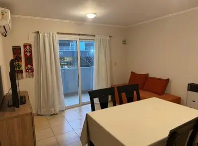 a living room with a table and chairs and a couch at Departamento un dormitorio Frente al Pocito in Cordoba
