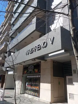 a store with a sign on the side of a building at Departamento un dormitorio Frente al Pocito in Cordoba