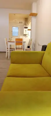 a green couch in a living room with a table at Depto Privado Quality in Cordoba