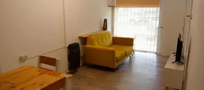 a living room with a yellow chair and a table at Depto Privado Quality in Cordoba