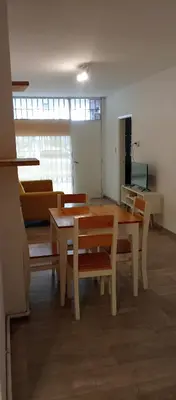 a room with a table and chairs and a couch at Depto Privado Quality in Cordoba