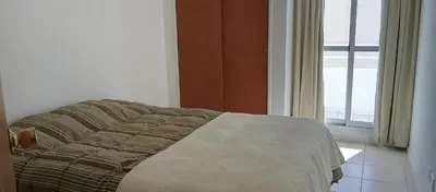 a bed sitting in a room with a window at Sol de Alberdi in Cordoba