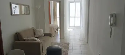 a living room with a couch and a chair and a window at Sol de Alberdi in Cordoba