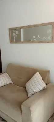 a brown couch in a living room with a mirror at Sol de Alberdi in Cordoba