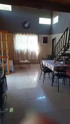 a room with a table and chairs and a window at Cabaña Mitimay in Alta Gracia