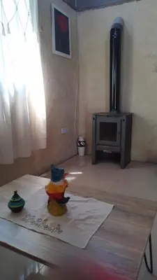 a figurine sitting on a table in a living room at Cabaña Mitimay in Alta Gracia