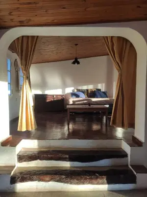 a living room with a bed and a couch at La Pasionaria, casa de campo con pileta in Villa García