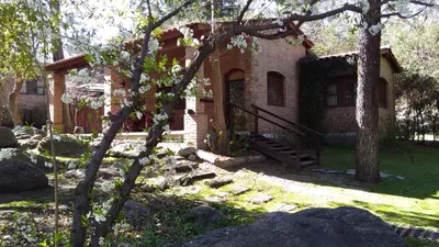 a brick house with a staircase in the yard at Las Nubes Cabañas & Loft in San Javier