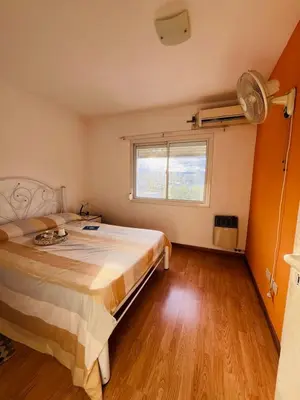 a bedroom with a large bed and a window at Carlos Paz Tupungato in Villa Carlos Paz