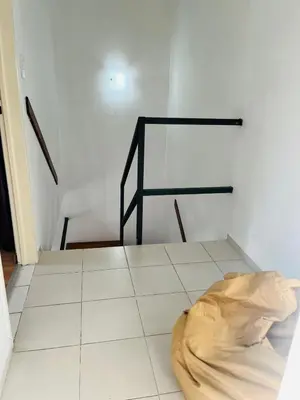 a room with a staircase with a bag on the floor at Carlos Paz Tupungato in Villa Carlos Paz