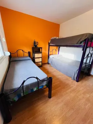two bunk beds in a room with orange walls at Carlos Paz Tupungato in Villa Carlos Paz