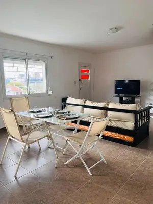a living room with a table and chairs and a couch at Carlos Paz Tupungato in Villa Carlos Paz