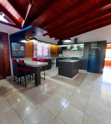 a kitchen with a table and chairs in a room at Casita serrana in Villa Santa Cruz del Lago