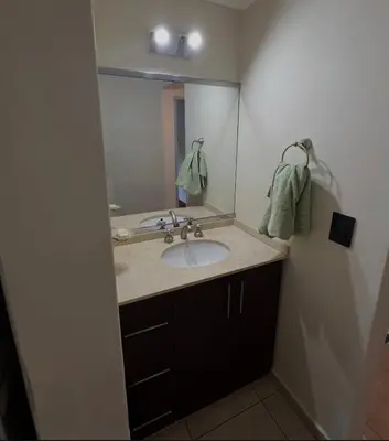a bathroom with a sink and a large mirror at Casita serrana in Villa Santa Cruz del Lago