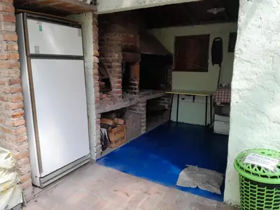 a garage with a white door and a brick wall at Rafael Arcangel in Nono