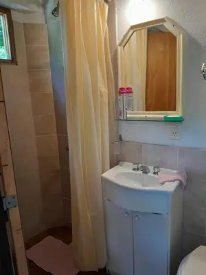 a bathroom with a sink and a shower with a mirror at Rafael Arcangel in Nono