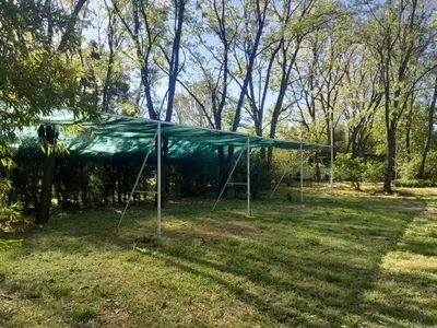 a green tent in a field with trees at Rafael Arcangel in Nono