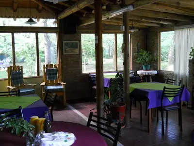 a restaurant with purple and green tables and chairs at Rafael Arcangel in Nono
